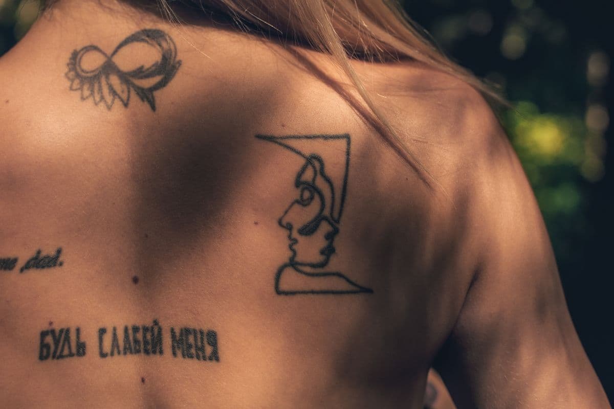 Fine line tattoos on a woman’s back