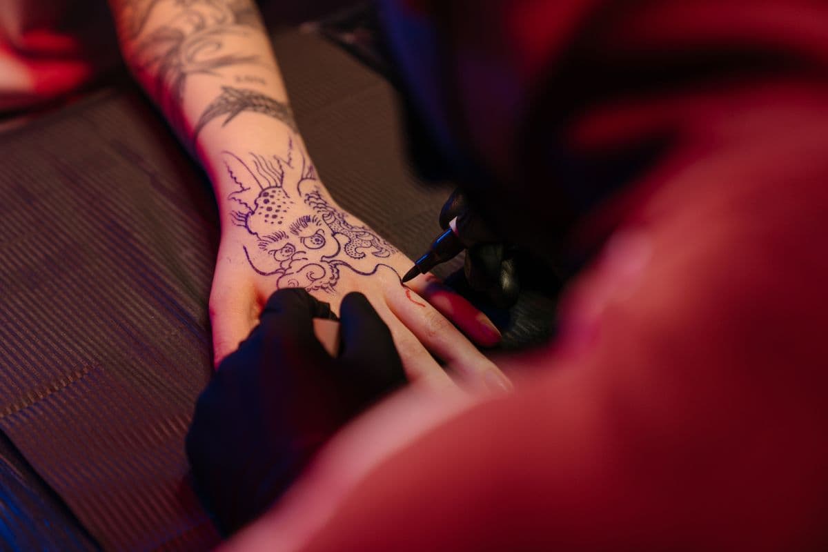 Dragon tattoo across a hand