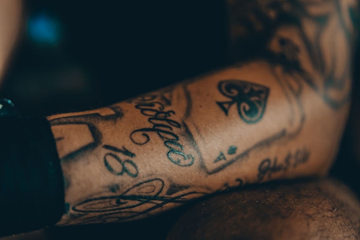 Intricate forearm tattoo in low light