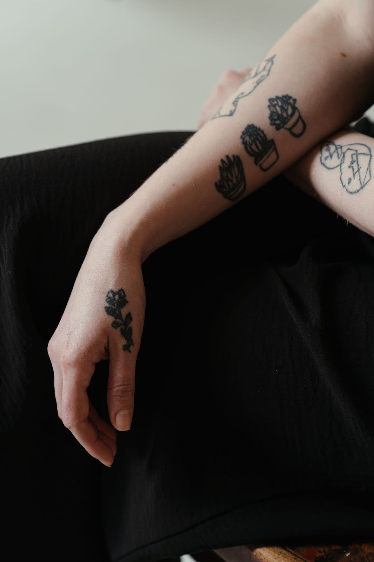 Floral and geometric tattoos on an arm